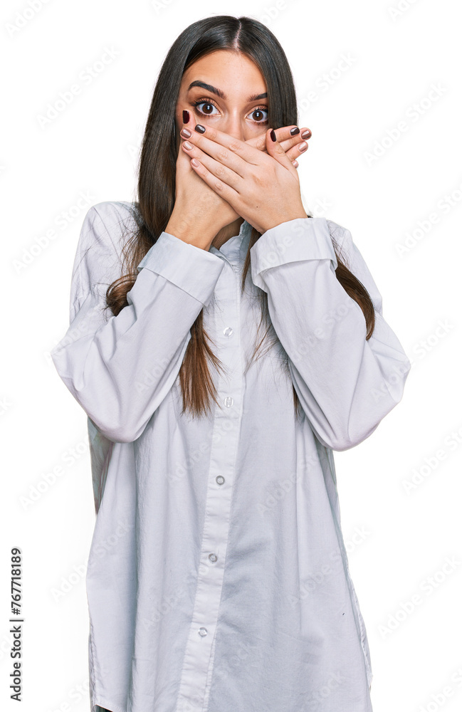 Young beautiful woman wearing casual white shirt shocked covering mouth with hands for mistake. secret concept. Young beautiful woman wearing casual white shirt shocked covering mouth with hands for mistake. secret concept.