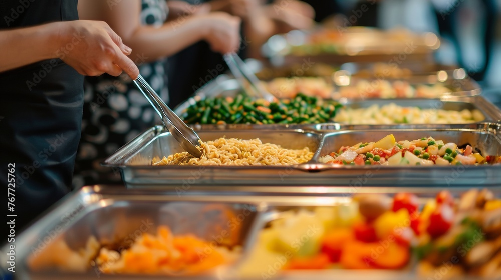 Obraz premium People serving various delicious dishes from a buffet spread at an event.