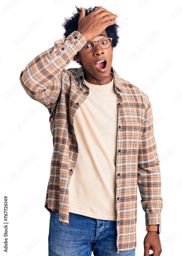 Handsome african american man with afro hair wearing casual clothes and glasses surprised with hand on head for mistake, remember error. forgot, bad memory concept. Handsome african american man with afro hair wearing casual clothes and glasses surprised with hand on head for mistake, remember error. forgot, bad memory concept.