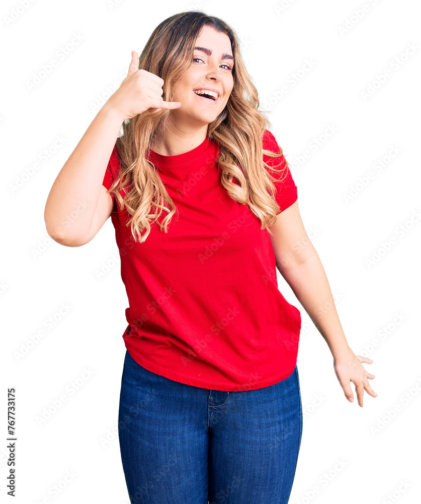 Young caucasian woman wearing casual clothes smiling doing phone gesture with hand and fingers like talking on the telephone. communicating concepts. Young caucasian woman wearing casual clothes smiling doing phone gesture with hand and fingers like talking on the telephone. communicating concepts.