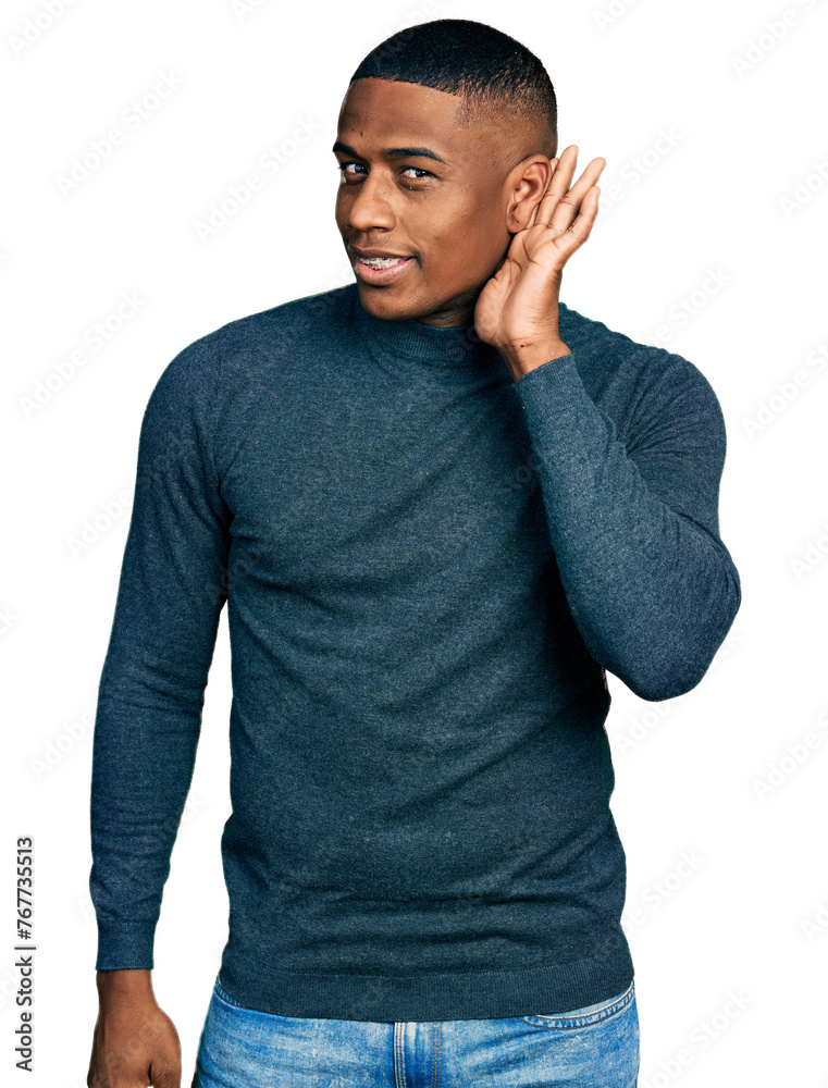 Young black man wearing casual sweater smiling with hand over ear listening and hearing to rumor or gossip. deafness concept. Young black man wearing casual sweater smiling with hand over ear listening and hearing to rumor or gossip. deafness concept.