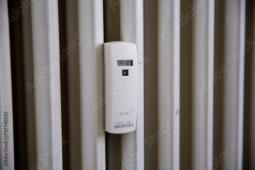Close up of a wireless heat meter on white radiator. Heating of houses in the cold season