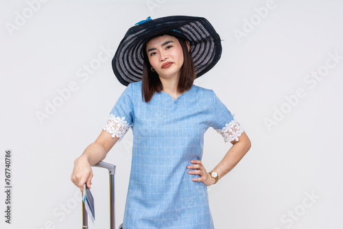 An upset and irked Asian female tourist in blue dress looking annoyed at her companion. isolated on white