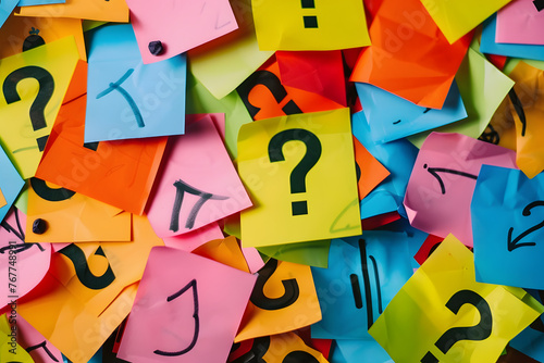 a pile of colorful post - it notes with question marks on them and a question mark in the middle of the post - it notes.