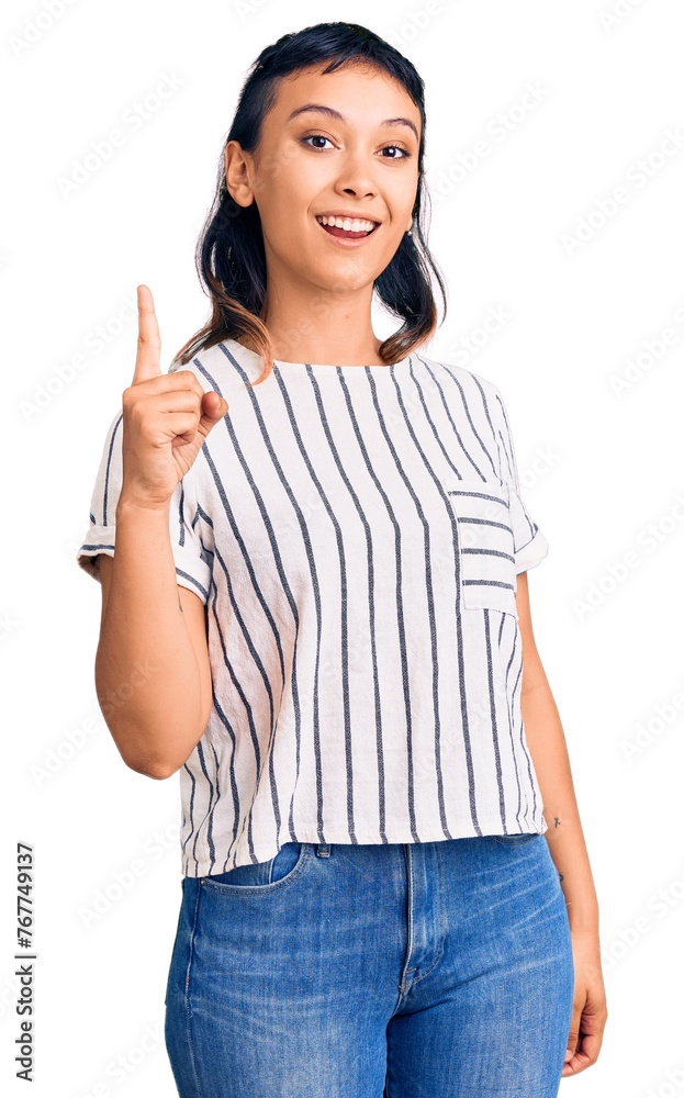 Young woman wearing casual clothes pointing finger up with successful idea. exited and happy. number one. Young woman wearing casual clothes pointing finger up with successful idea. exited and happy. number one.