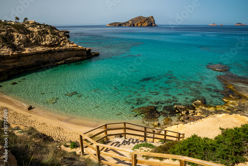 Cala Comte beach with turquoise waters and the view of S´ Espartar island in the background, Sant Josep de Sa Talaia, Ibiza, Balearic Islands, Spain photo