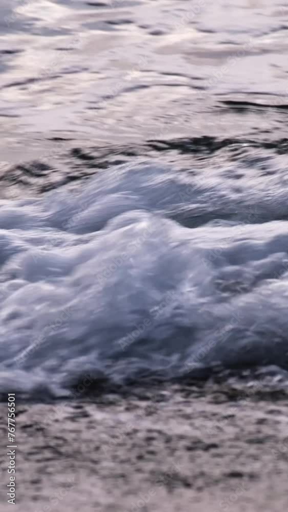 Abstract slow motion blue and grey waves with white foam swirling and splashing on the beach. Waves crashing on the Adriatic Sea coastline. Close-up of continuously changing disquiet sea surface. Abstract slow motion blue and grey waves with white foam swirling and splashing on the beach. Waves crashing on the Adriatic Sea coastline. Close-up of continuously changing disquiet sea surface.