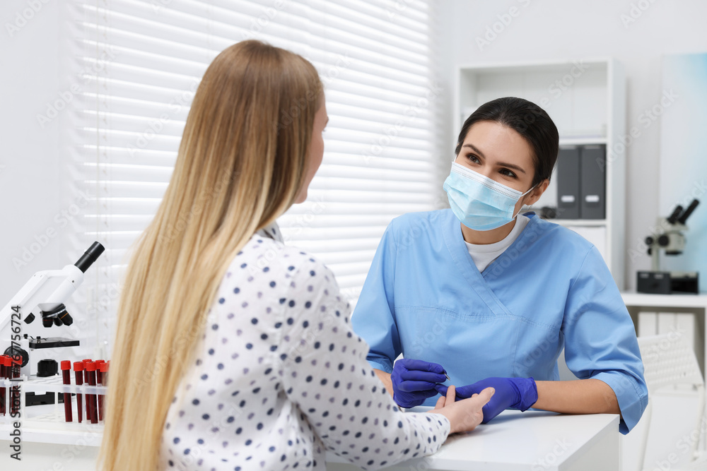 Laboratory testing. Doctor taking blood sample from patient at white table in hospital Laboratory testing. Doctor taking blood sample from patient at white table in hospital