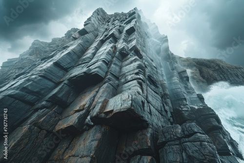 Dangerous, steep cliff with jagged rocks against  sky, capturing the raw power of nature