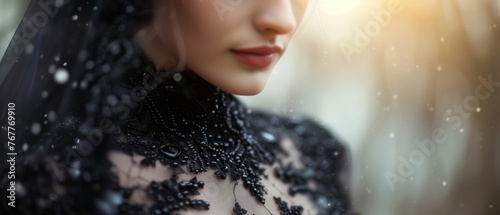 Elegant woman in black dress with veil on head