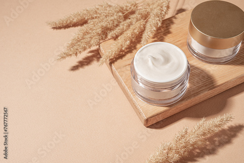 Jars of cosmetic cream with pampas grass