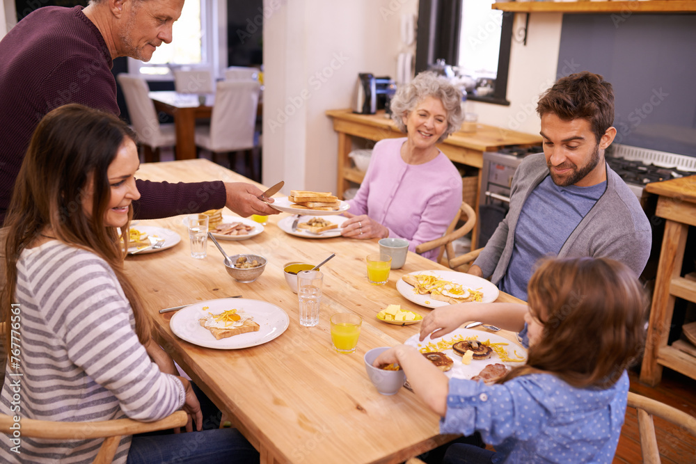 Love, breakfast and big family in a kitchen with pancakes, eating or bonding at a table together. Food, diet and kid with people in a house with waffle for brunch, nutrition or communication at home