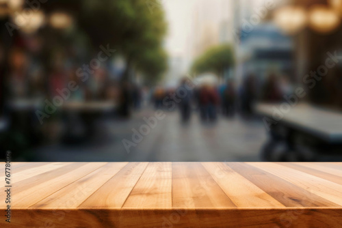 Empty wooden table with a blurred city street in the background. High quality photo © oksa_studio