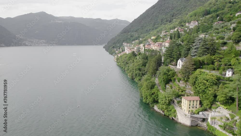 Italian Lake With Mountainside Villages In Lago di Como, Lombardy, Italy. Aerial Drone Shot Italian Lake With Mountainside Villages In Lago di Como, Lombardy, Italy. Aerial Drone Shot