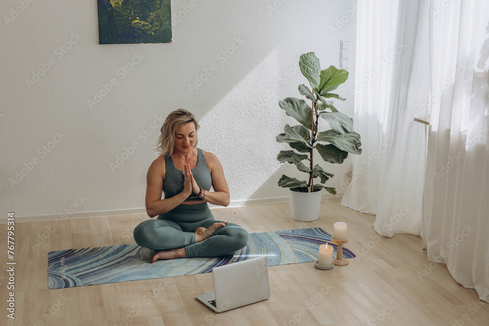 A 50-year-old woman doing online yoga at home A 50-year-old woman doing online yoga at home