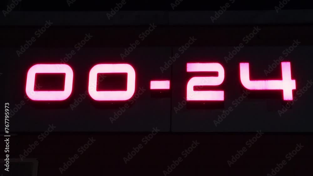a close up of a huge working time 00-24 on a building's wall a close up of a huge working time 00-24 on a building's wall