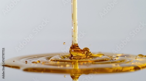 Golden honey pouring and splashing on reflective surface, illustrating texture and viscosity of natural sweeteners. Food photography and culinary arts.