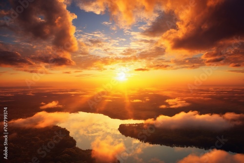 a beautiful dramatic sunset sky with cumulus clouds over the forest and river, a bird's-eye view