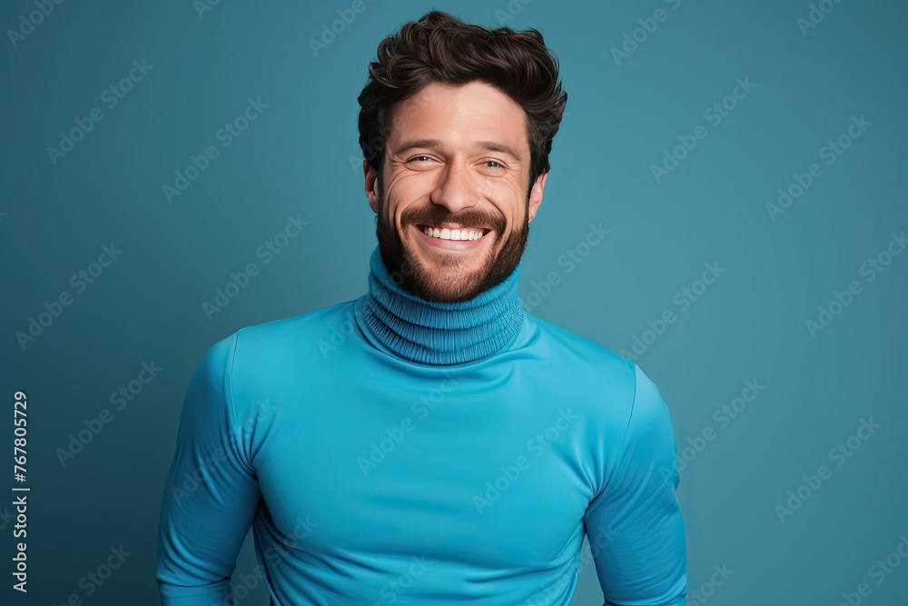 A man in a blue sweater is smiling and looking at the camera A man in a blue sweater is smiling and looking at the camera