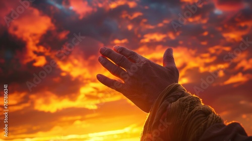 A close-up in the Bible showing the hands of Jesus Christ amidst an evening sunset. Stunningly beautiful sky