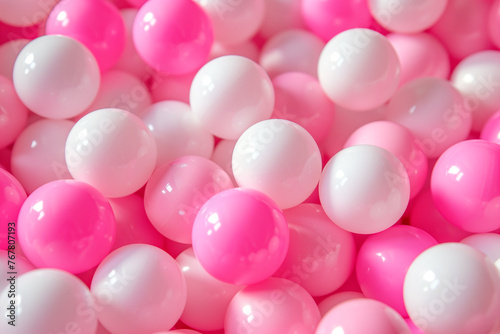A bunch of pink and white balls are piled on top of each other. The pink and white balls are arranged in a way that creates a sense of depth and texture. The image conveys a playful and fun mood