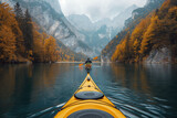 back of male kayaker kayaking on a lake with a landscape of mountain peaks and forests in nature in autumn