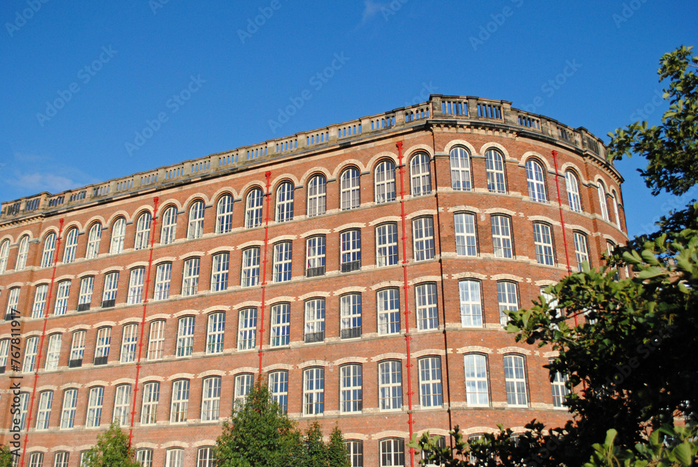 Renovated 19th Century Cotton Spinning Mill seen against Blue Sky