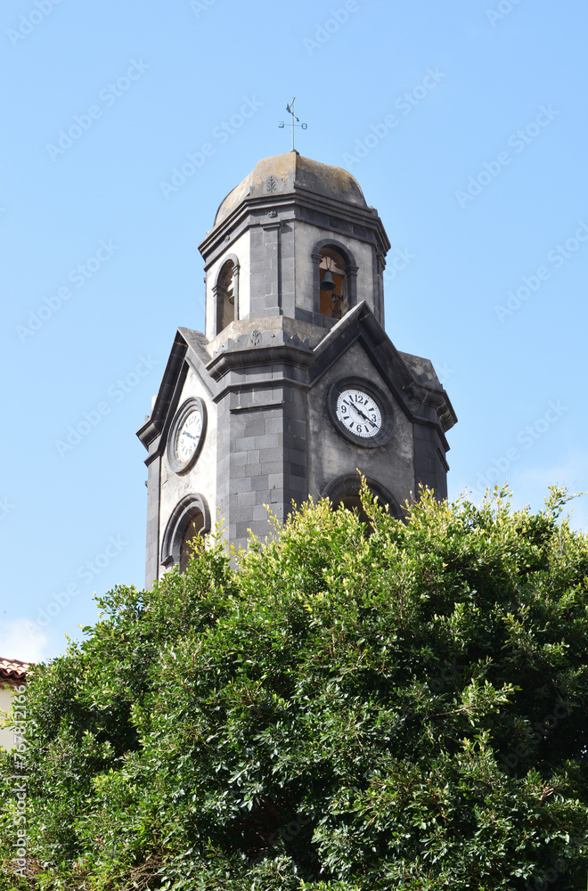 Spanish Stone Church Tower with Cupola and Clock seen from Below