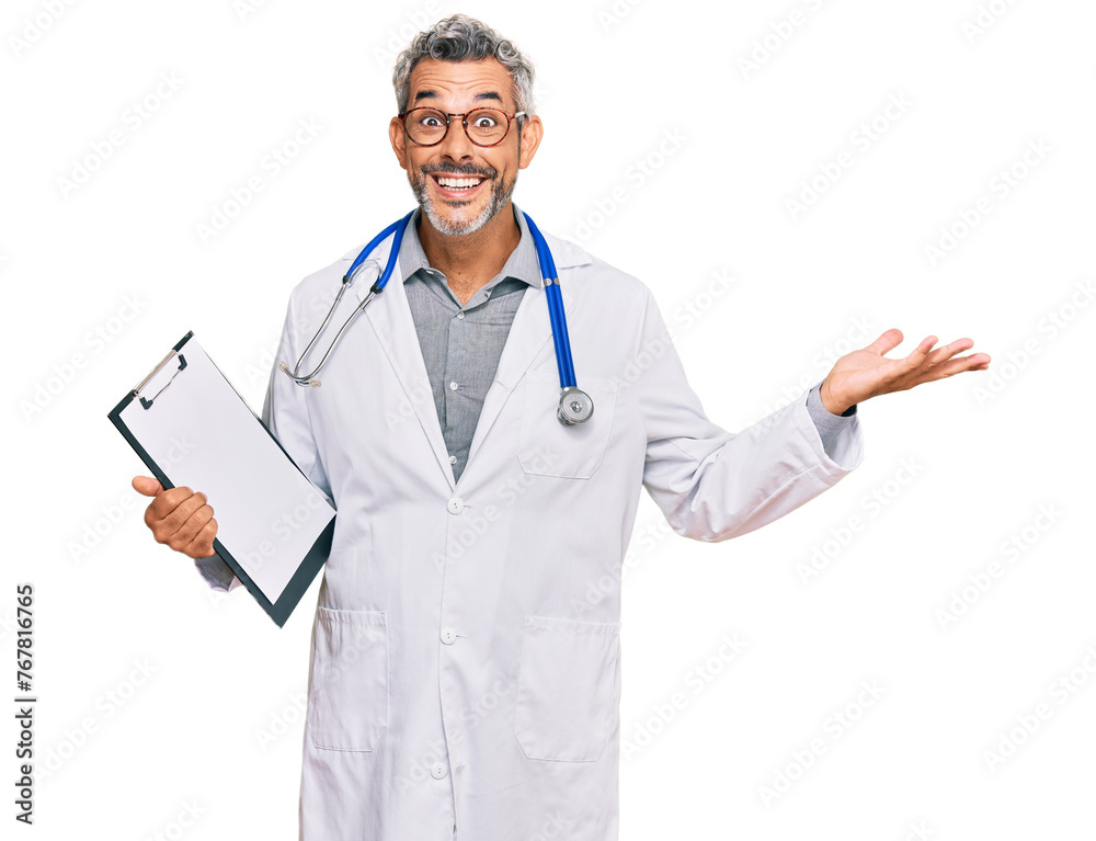 Middle age grey-haired man wearing doctor stethoscope holding clipboard celebrating victory with happy smile and winner expression with raised hands Middle age grey-haired man wearing doctor stethoscope holding clipboard celebrating victory with happy smile and winner expression with raised hands
