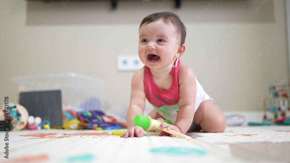 Fototapeta premium baby play with toys on the indoor floor. kindergarten a family dream concept. joyful moments: baby playtime family with toys on the indoor floor. baby play active time on lifestyle the indoor floor