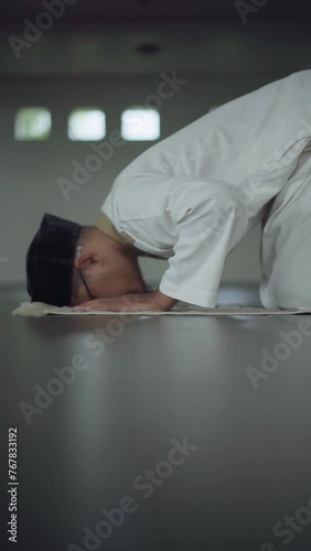 Asian moslem praying in mosque. islamic religion. During Ramadan he often prays in the mosque, worships, reads the Koran, makes dhikr, and prays to Allah.
