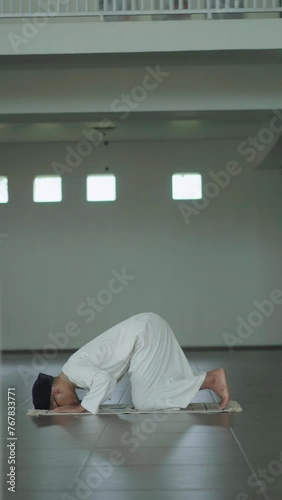 Asian moslem praying in mosque. islamic religion. During Ramadan he often prays in the mosque, worships, reads the Koran, makes dhikr, and prays to Allah.