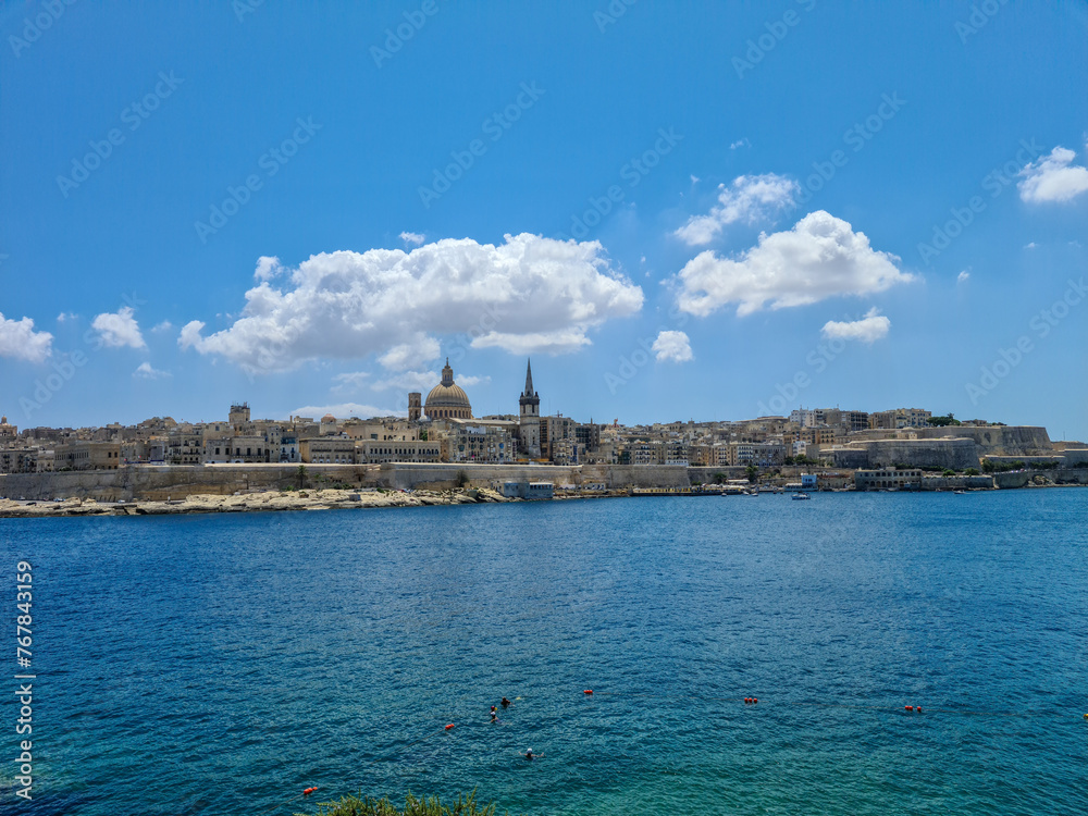 Valletta, Malta - August 8th 2020: Blue sky and clouds above the fortified capital city overlooking Marsamxett Harbour.