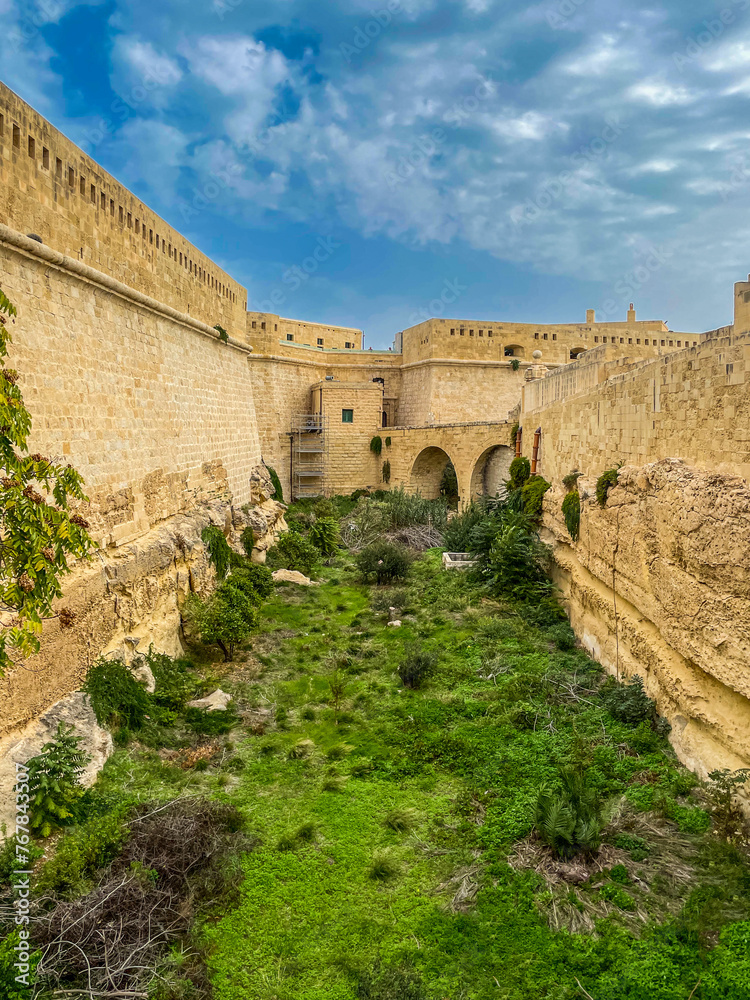 Valletta, Malta - October 23rd 2021: The defensive ditch alongside the Right Demi Bastion at Fort Saint Elmo a star fort built in the 16th century by the Order of St. John.