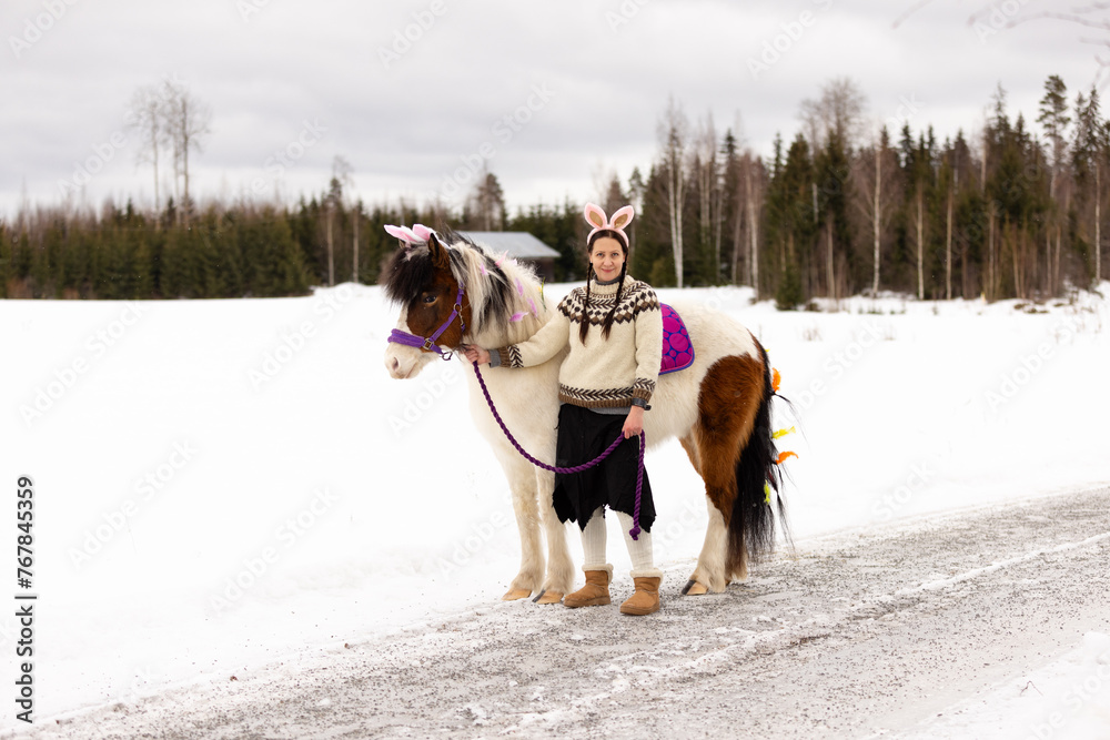 Eastern decorated Icelandic horse and Eastern bunny dressed woman with the horse