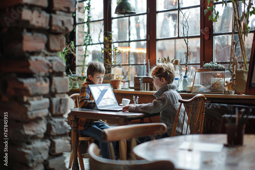 Young entrepreneurs discussing ideas over laptop in a cozy cafe