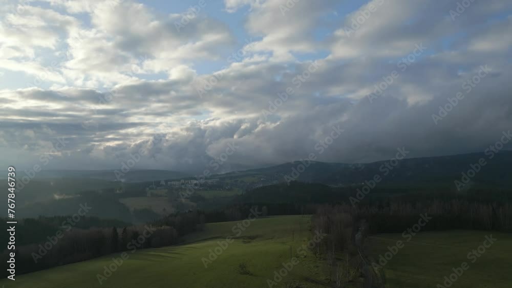 Breathtaking view of a landscape with rolling hills, green fields, and a sky filled with fluffy clouds. Breathtaking view of a landscape with rolling hills, green fields, and a sky filled with fluffy clouds.
