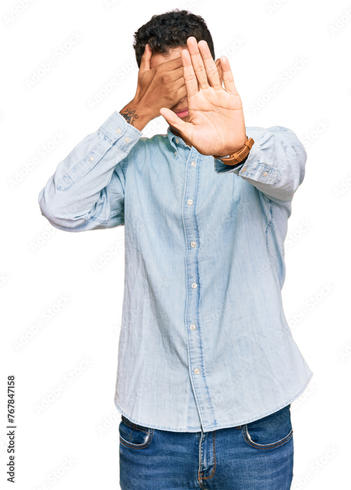 Young handsome african american man wearing casual clothes covering eyes with hands and doing stop gesture with sad and fear expression. embarrassed and negative concept. Young handsome african american man wearing casual clothes covering eyes with hands and doing stop gesture with sad and fear expression. embarrassed and negative concept.