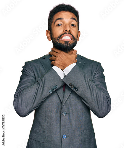 Young african american man wearing business clothes shouting and suffocate because painful strangle. health problem. asphyxiate and suicide concept.