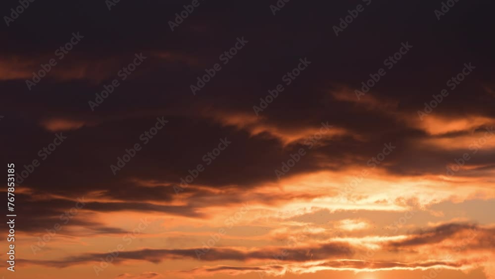 Time lapse of huge fluffy orange purple clouds fast moving on sunset sky in pastel colors Time lapse of huge fluffy orange purple clouds fast moving on sunset sky in pastel colors