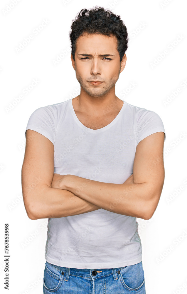 Young handsome man wearing casual white t shirt skeptic and nervous, disapproving expression on face with crossed arms. negative person. Young handsome man wearing casual white t shirt skeptic and nervous, disapproving expression on face with crossed arms. negative person.