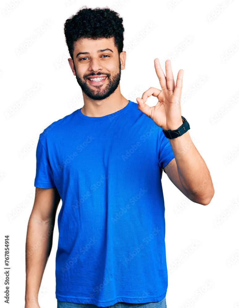 Young arab man with beard wearing casual blue t shirt smiling positive doing ok sign with hand and fingers. successful expression. Young arab man with beard wearing casual blue t shirt smiling positive doing ok sign with hand and fingers. successful expression.