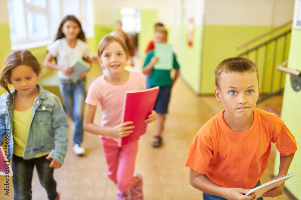 Kids running in school hallway during recess Kids running in school hallway during recess