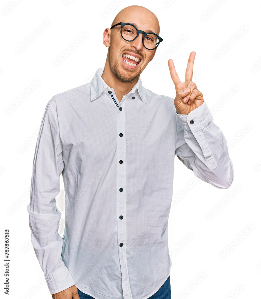Bald man with beard wearing business shirt and glasses smiling with happy face winking at the camera doing victory sign. number two. Bald man with beard wearing business shirt and glasses smiling with happy face winking at the camera doing victory sign. number two.
