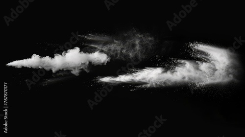 An isolated set of dust powder splash clouds on a black background