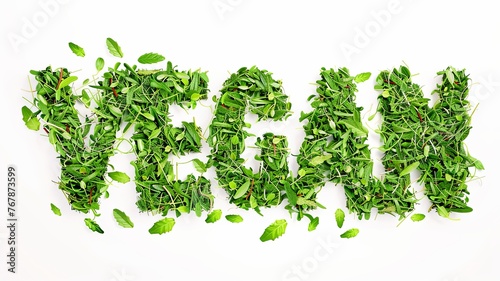 word vegan written in grass and leaves