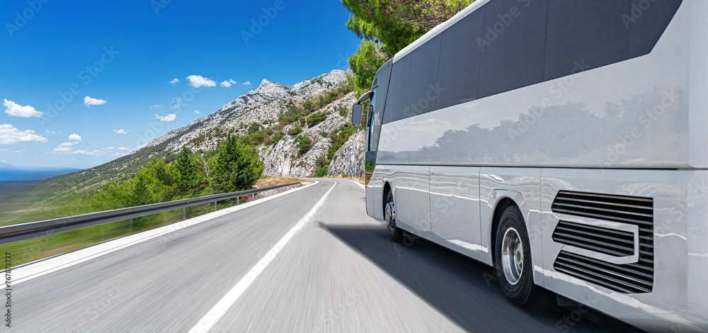 Tourist bus on a mountain road by the sea. Tourist travel concept.