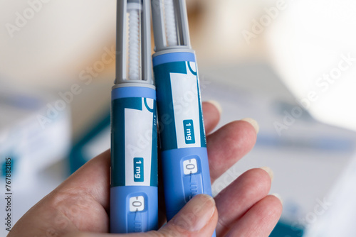 Hand holding Ozempic Insulin injection pen for diabetics. photo
