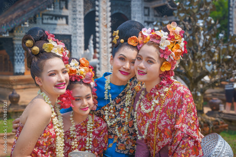 Songkran festival . Pretty Asian women playing with water-splashing Songkran. Beautiful Thai traditional dress costumes according to Thai culture to celebrate of the people Thailand New Year.