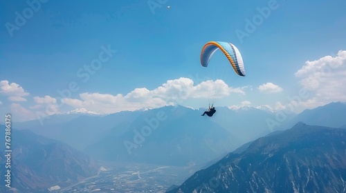 Paraglider soaring high with a breathtaking view of the mountains below, freedom theme no dust